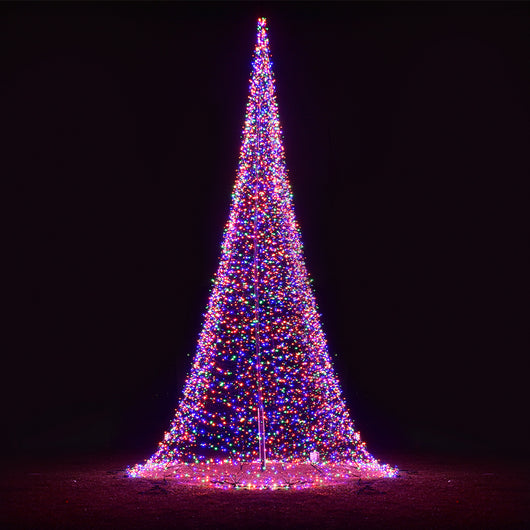 Colorful cone-shaped flagpole LED Christmas tree 23 ft tall glowing against a dark night background