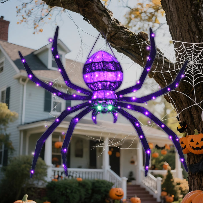 HOYECHI hanging Halloween spider with purple lights and green eyes displayed on a tree beside decorative webs.