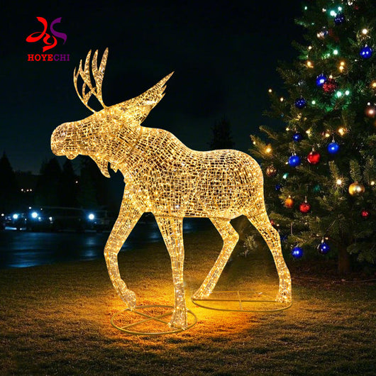 Outdoor LED Christmas elk sculpture by HOYECHI standing beside decorated Christmas tree ideal for park and commercial plaza displays