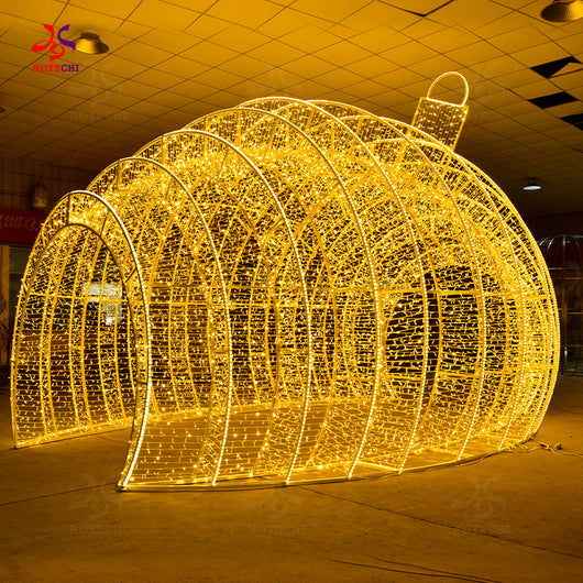 Three quarter angle of HOYECHI Christmas ball arch showing curved LED structure of giant ornament tunnel for city square and mall entrances