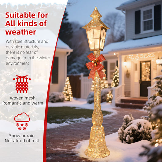 Lighted gold Christmas street lamp illuminating a snowy front yard walkway and winter holiday garden display