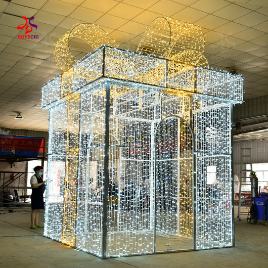 Side angle of HOYECHI LED gift box arch showing aluminum frame and bow-shaped top for festive home and garden displays
