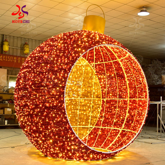 Side view of HOYECHI outdoor LED Christmas ball arch showing walk-through tunnel structure and giant ornament sphere design