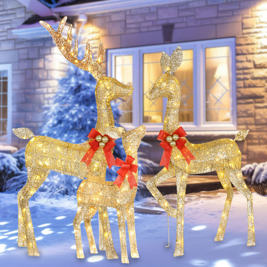 HOYECHI Christmas reindeer 3-piece lighted yard set illuminating a snowy front yard at night
