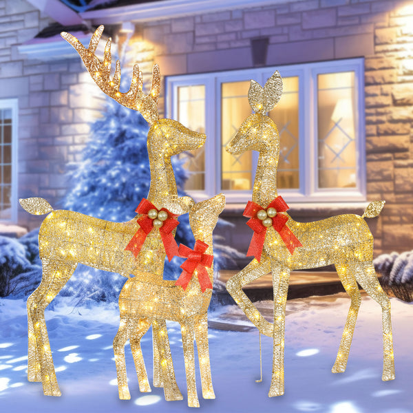 HOYECHI Christmas reindeer 3-piece lighted yard set illuminating a snowy front yard at night