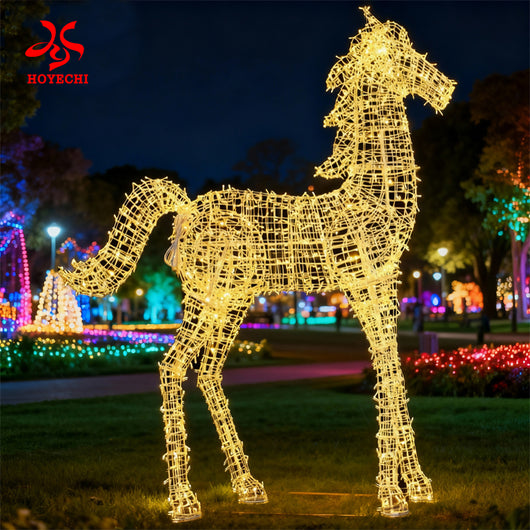 Outdoor LED horse light sculpture installed in a park night display with colorful trees