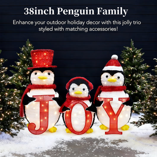 38 inch HOYECHI Christmas penguin family with JOY sign enhancing outdoor holiday decor among lighted trees