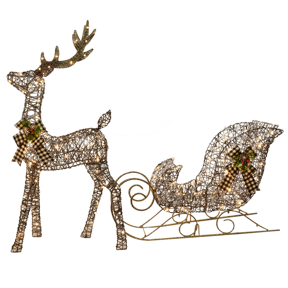Lighted reindeer and sleigh shown together in one Christmas display