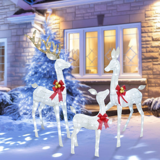 Outdoor front yard decorated with HOYECHI white LED reindeer family lights at night