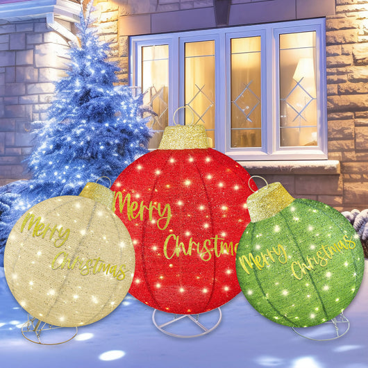 Outdoor front yard decorated with HOYECHI red green gold LED Christmas balls glowing at night