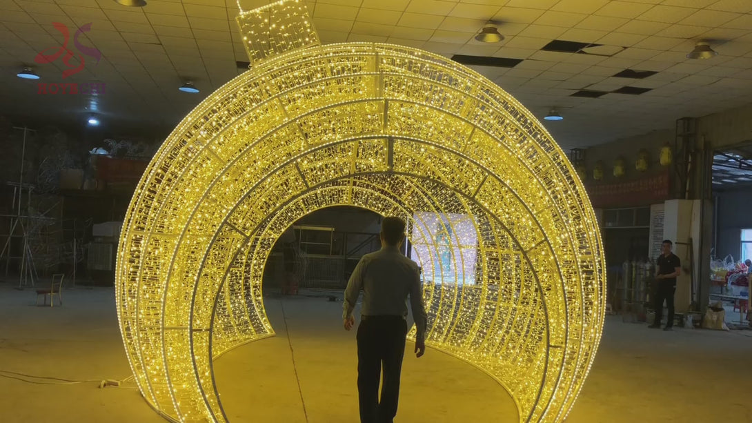 Video of HOYECHI Christmas ball arch festive outdoor LED giant ornament arch with people walking through for photo spot